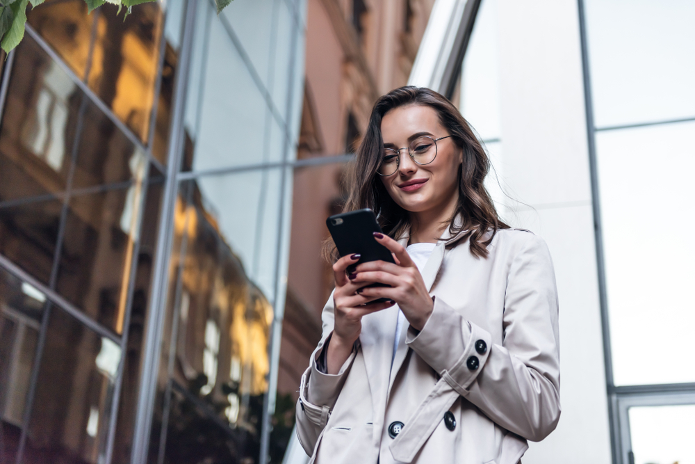 Smiling,Curly,Woman,Wearing,Trendy,Sunglasses,Walks,Down,The,Central